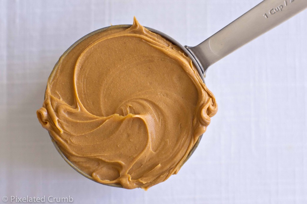 1 cup measuring spoon with peanut butter