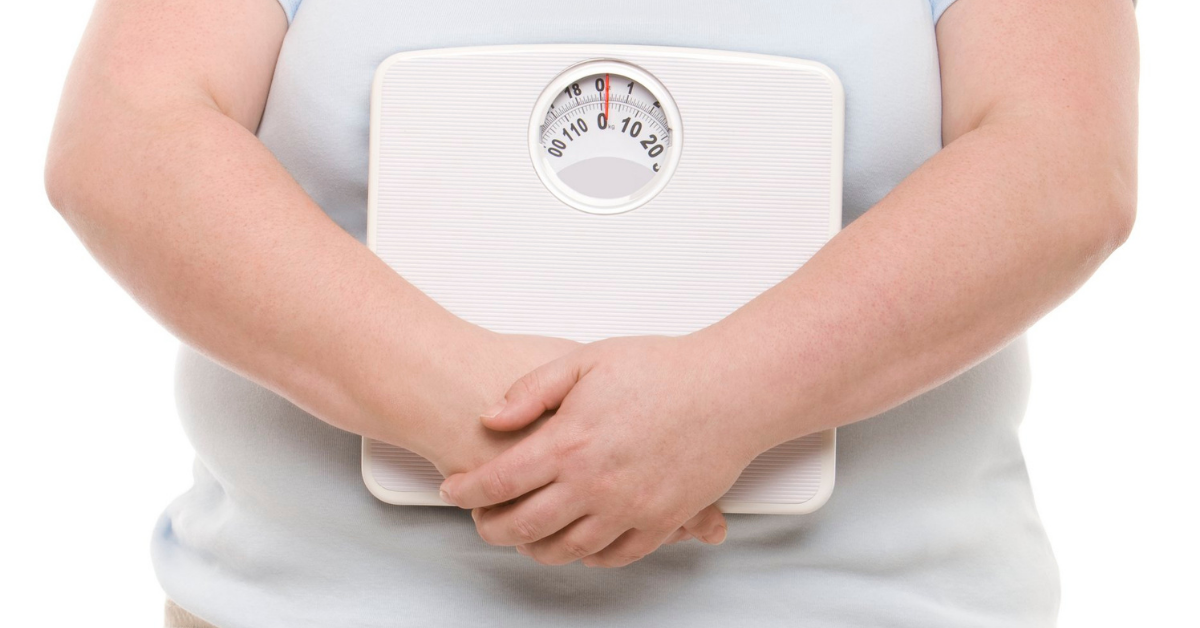 Person holding a body weight scale in their hands
