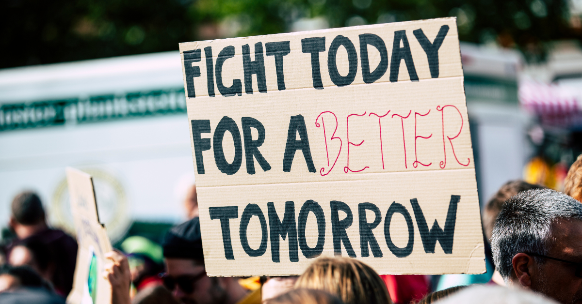 a sign reads "fight today for a better tomorrow"