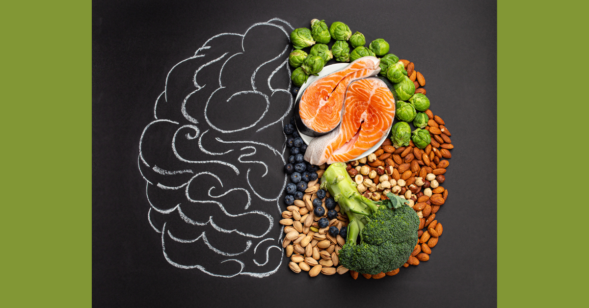 A chalk drawing of a brain on a black background with the right-hand portion depicting a variety of brain-healthy foods (salmon, broccoli, nuts)